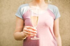 Female Hand Holds A Glass Of Champagne Royalty Free Stock Photos