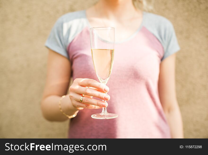 Female Hand Holds A Glass Of Champagne