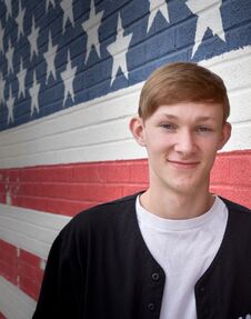 American Teenage Boy In Front Of American Flag Wall Royalty Free Stock Photography