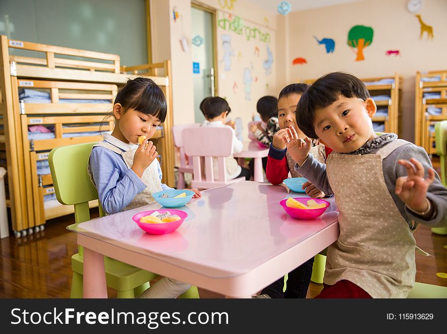 Three Toddler Eating on White Table