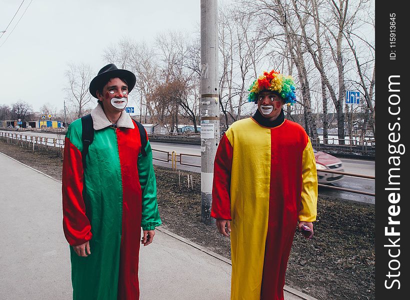 Photography of Two Clowns in the Street