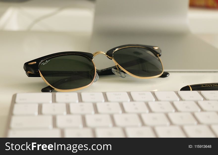 Black Ray-ban Clubmaster Sunglasses on White Surface