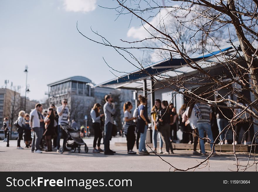 Blury Photograph Of People Beside White Building