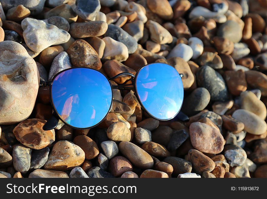 Black Farmed Sunglasses on Rocks