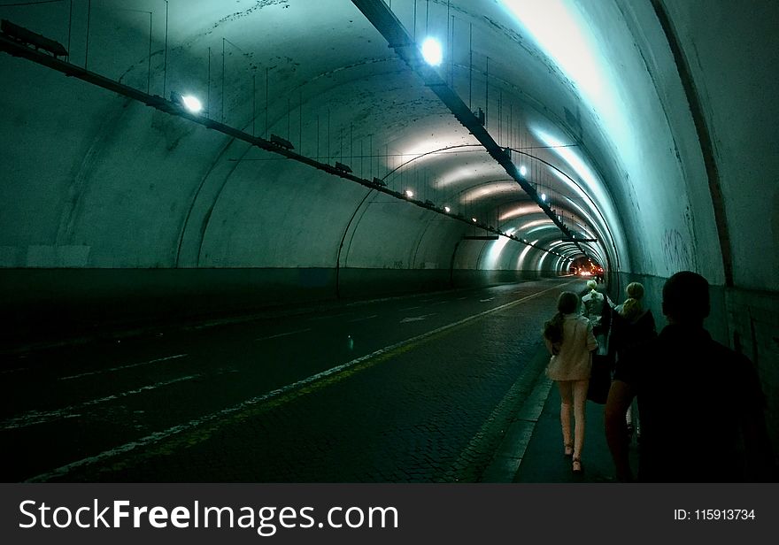 Group of Persons Passing by Tunnel