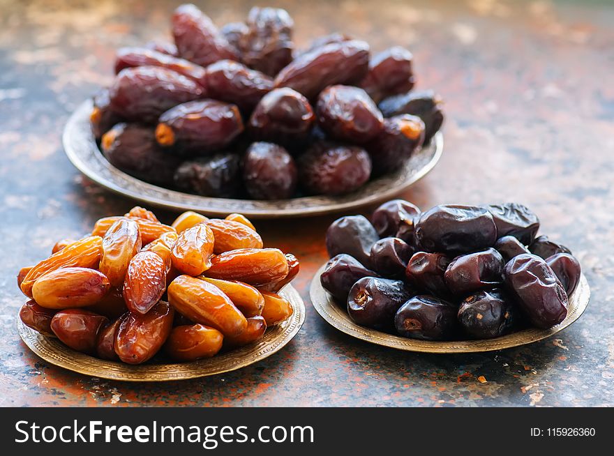 Various of dried dates or kurma in a vintage plates. Close up.