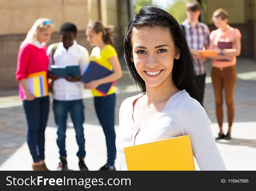 Young female student outdoors with her friends