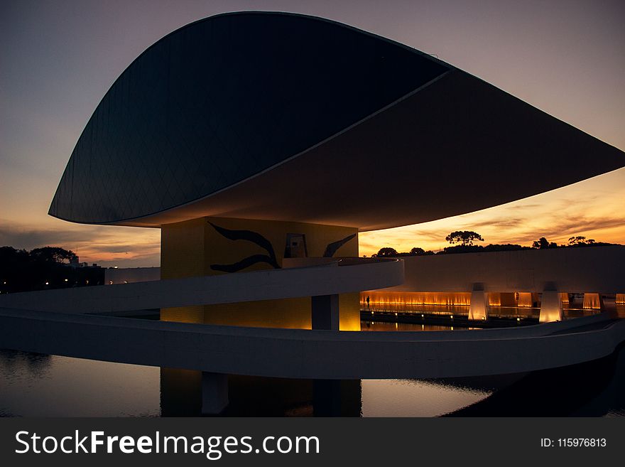 Black And Yellow Building During Orange Sunset