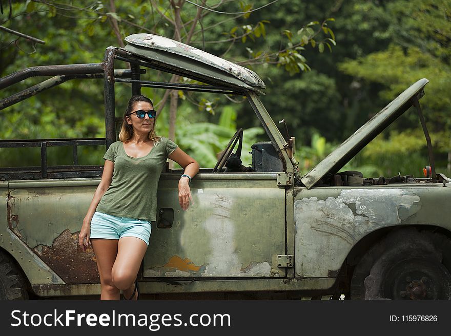 Woman Leaning on Wrangler With Hood Open
