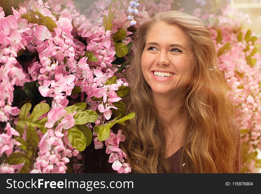 Photo Of Woman Standing Beside Pink Flowers