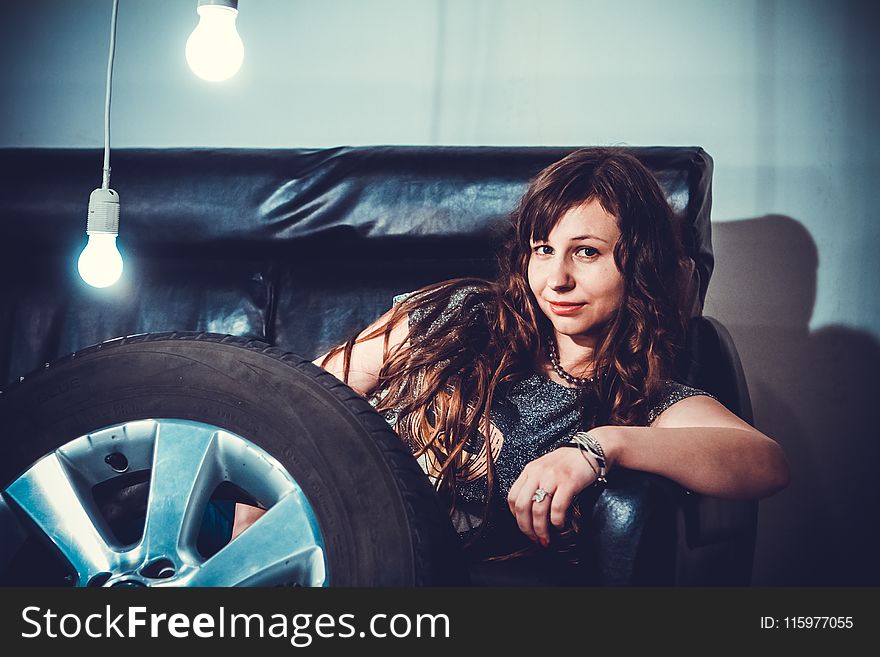 Photo of Woman Sitting on Couch Front of Wheel