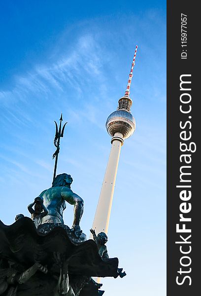 Low Angle Photo of Statue and Tower Structure