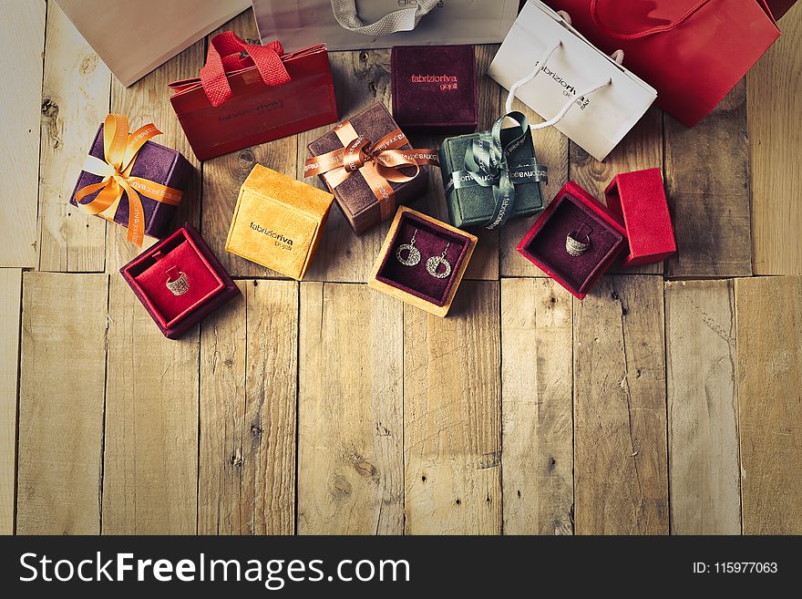 Assorted Gift Boxes on Brown Wooden Floor Surface