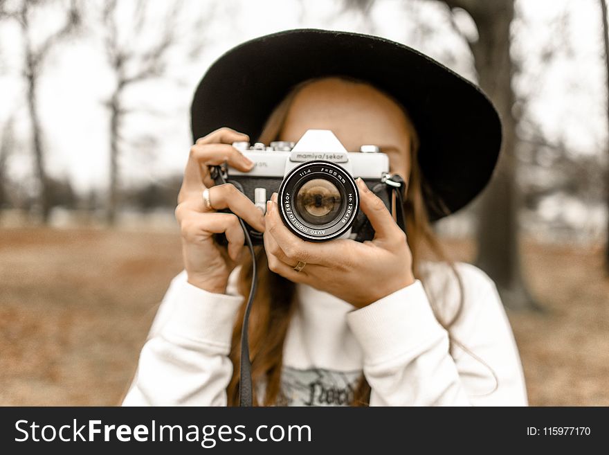 Selective Focus Photography of Woman Using White and Black Slr Camera