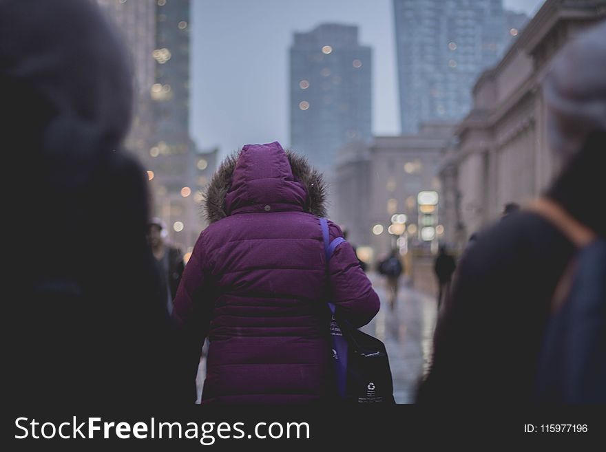 Selective Focus Photograph of Person Wearing Purple Hoodie Jacket Walking on Street