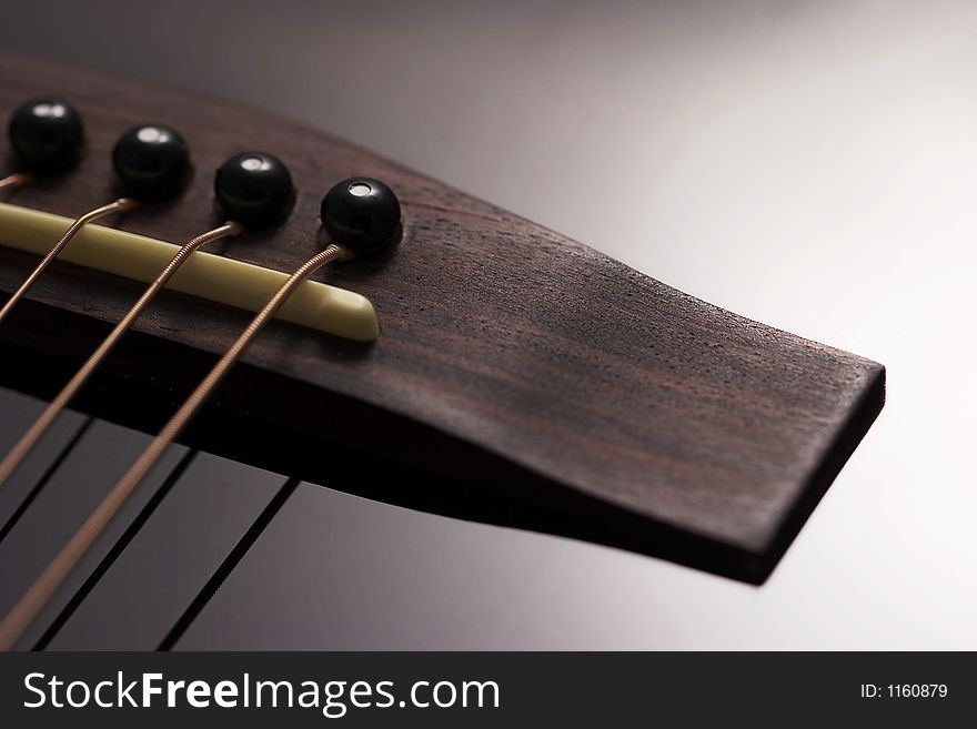 Close-up of acoustic guitar with pegs and strings in view. Close-up of acoustic guitar with pegs and strings in view