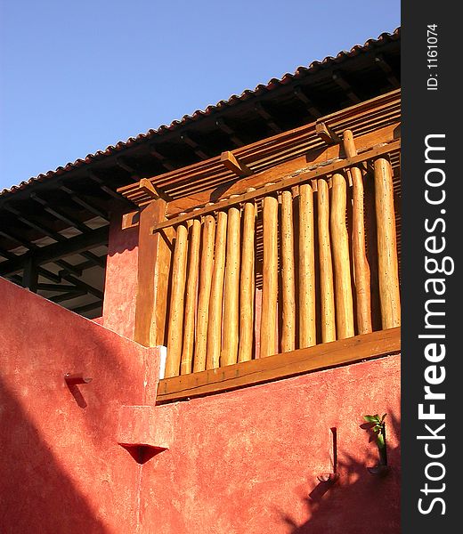A typical stucco building with a wooden deck screen in Careyes, Mexico. A typical stucco building with a wooden deck screen in Careyes, Mexico