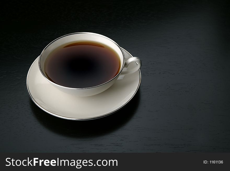 Cup of black coffe in a white saucer. Cup of black coffe in a white saucer.