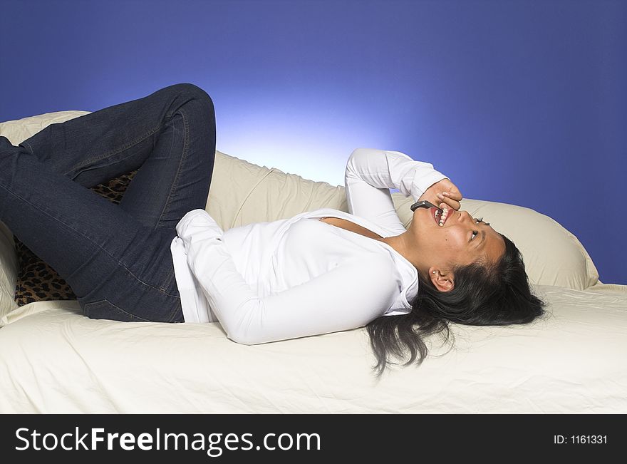 Girl laying down on couch with cell