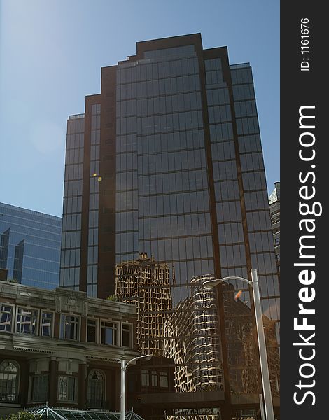 Downtown office building looking up toward the blue sky. Perfect for corporate brochure. Downtown office building looking up toward the blue sky. Perfect for corporate brochure.