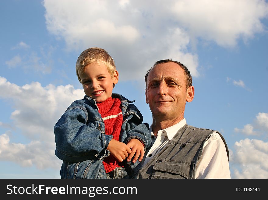 Grandfather with boy on sky