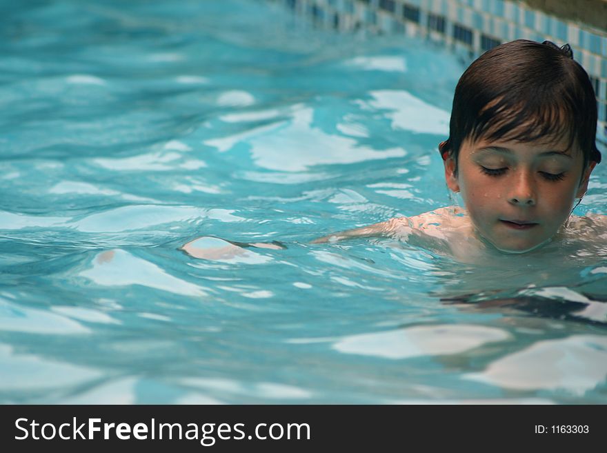 Child having fun swimming in pool. Child having fun swimming in pool