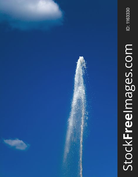Fountain on a background of the sky and a cloud. Fountain on a background of the sky and a cloud