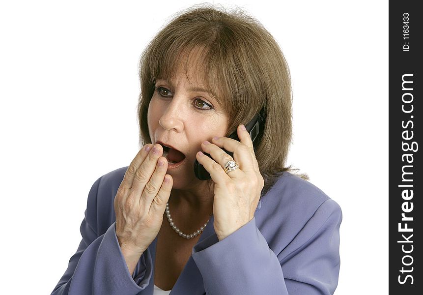 An attractive businesswoman shocked at office rumors she is hearing over the phone. Isolated. An attractive businesswoman shocked at office rumors she is hearing over the phone. Isolated.