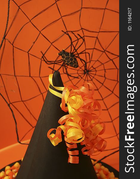 Halloween arrangement of witch's hat, spider web and candy corn. Halloween arrangement of witch's hat, spider web and candy corn