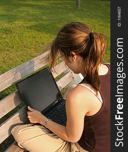 Student working on laptop in the Park