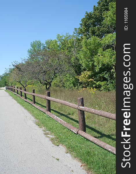 A wooden fence along a pathway