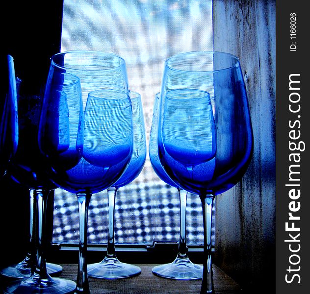 Blue glasses on the window-sill