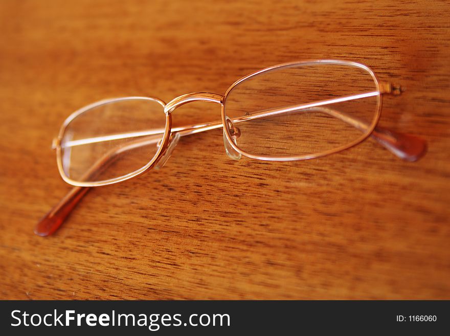 Pair of glasses on a wooden surface