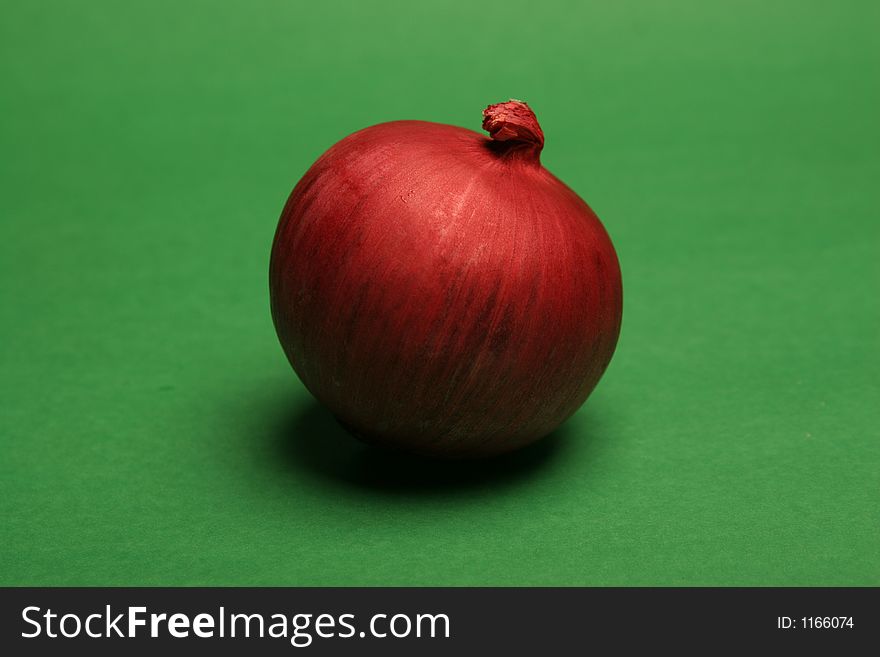 Red onion on a green surface