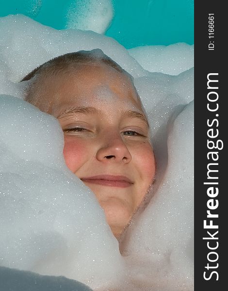 A child swimming in a pool of bubbles. A child swimming in a pool of bubbles