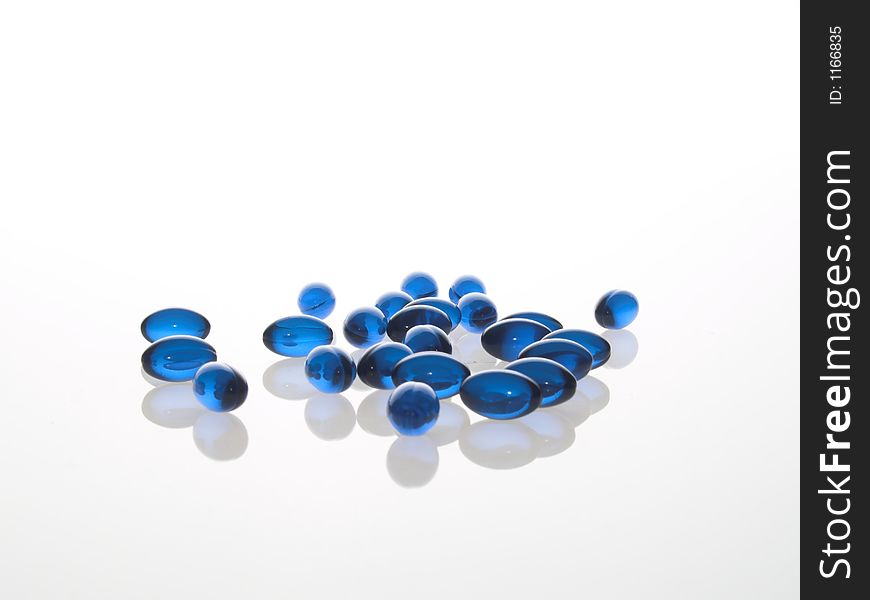 Blue medical gel capsules on white background. Blue medical gel capsules on white background