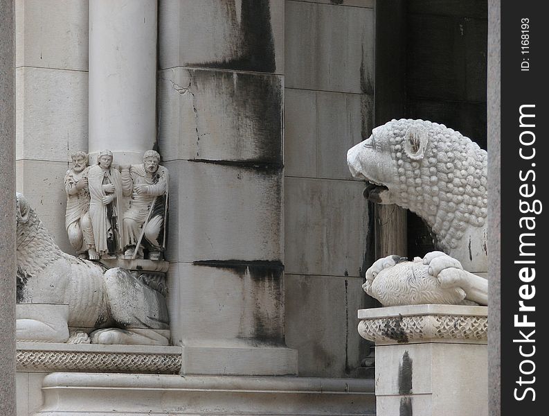 Saint is looking at angry lion. Saint is looking at angry lion