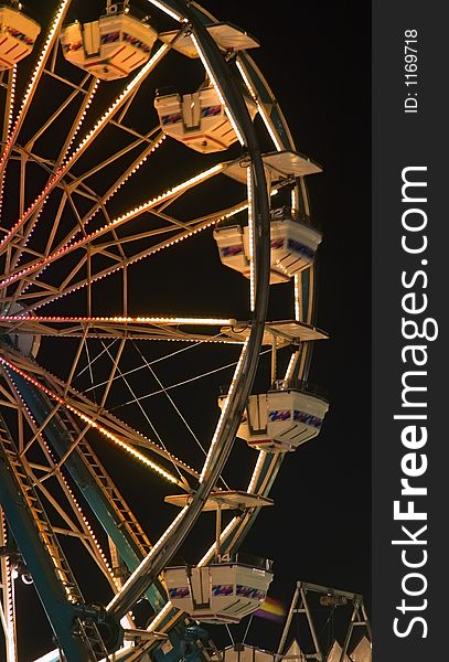 Nightime ferris wheel at rest - some motion blur on gondolas