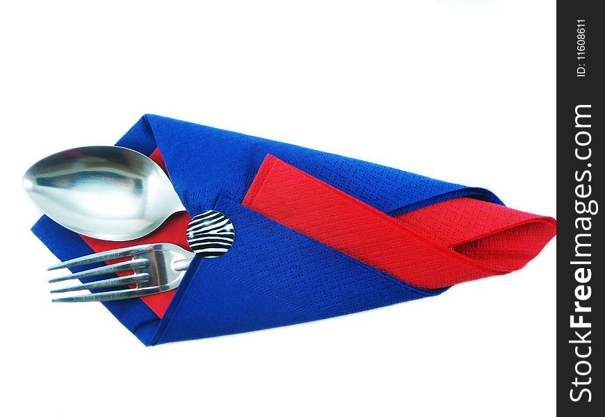 Dining facilities, plug and spoon in a red and dark blue napkin