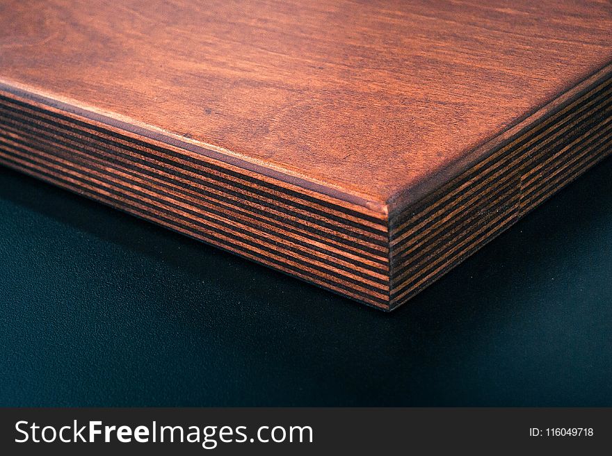 Brown Wooden Board Near Black Surface