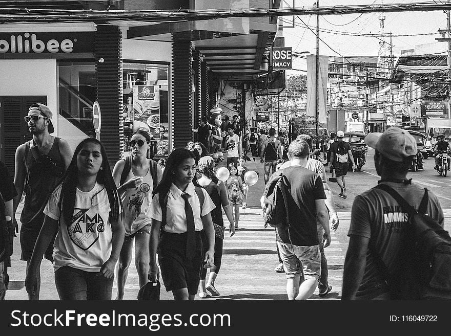 Grayscale Photo of People Walking in the Street