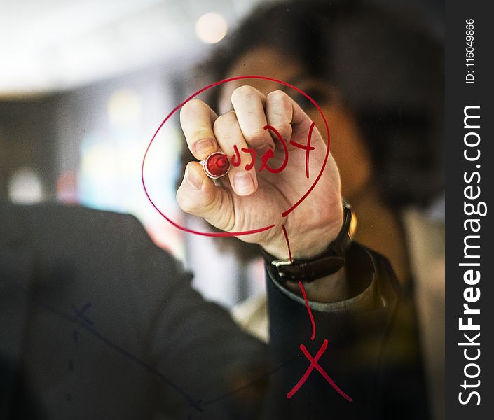 Person Wearing Black Watch Writing On Mirror Using Red Pen