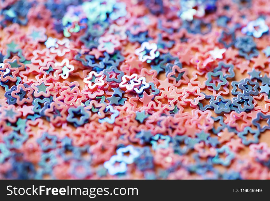 Shallow Focus Photography of Pink and Blue Star Figures