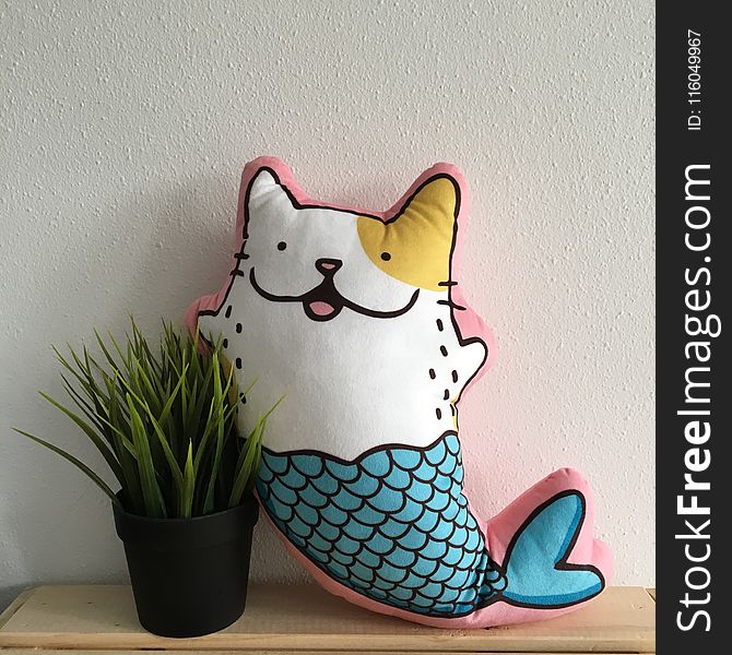 Mermaid Cat Pillow Beside Plant