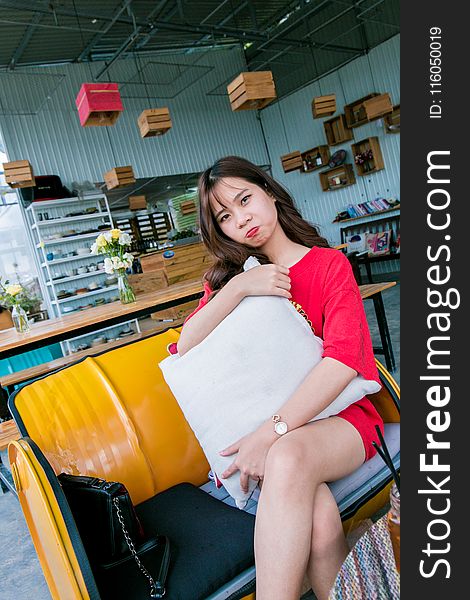 Woman Sitting On Yellow Couch