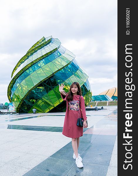 Woman in Front of Green Glass Building