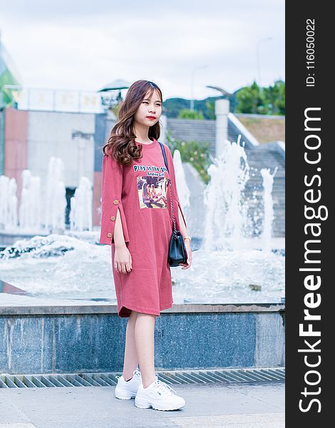 Woman Wearing Pink Dress Standing Near Water Fountain