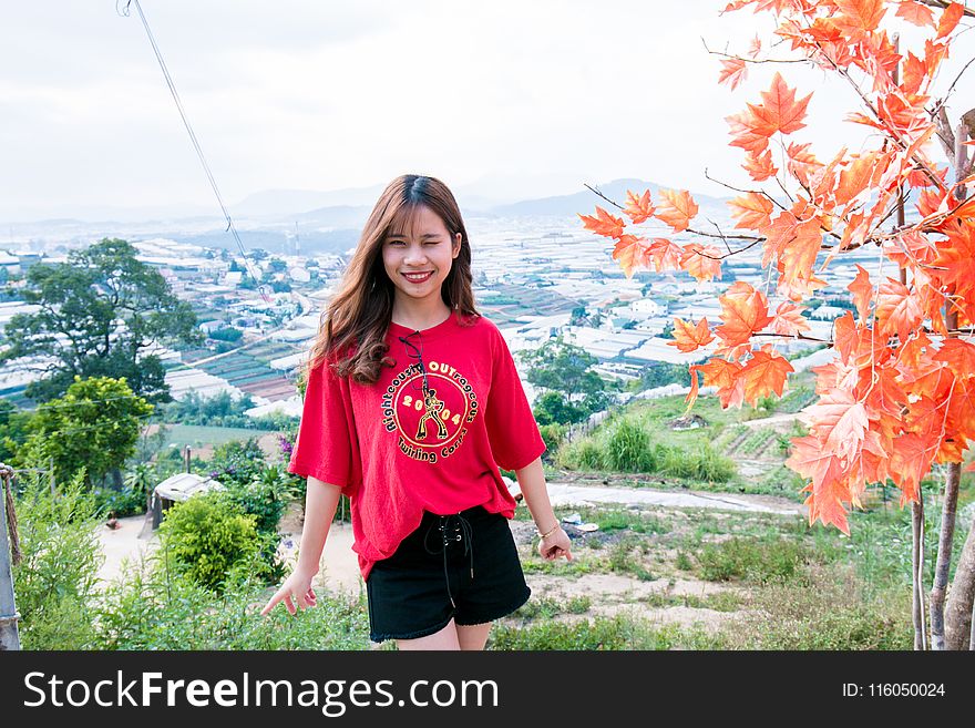 Woman in Red T-shirt and Black Shorts