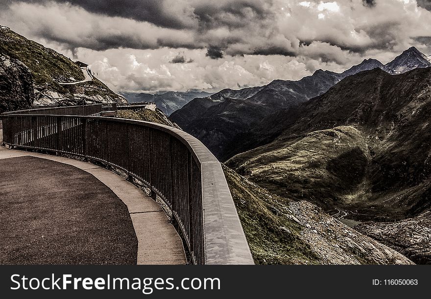 Gray Metal Railings On Top Of Hill Under Gray Cloudy Sky At Daytime