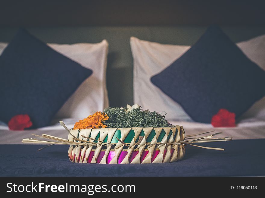 White and Green Table Decoration Near Two Black Pillows